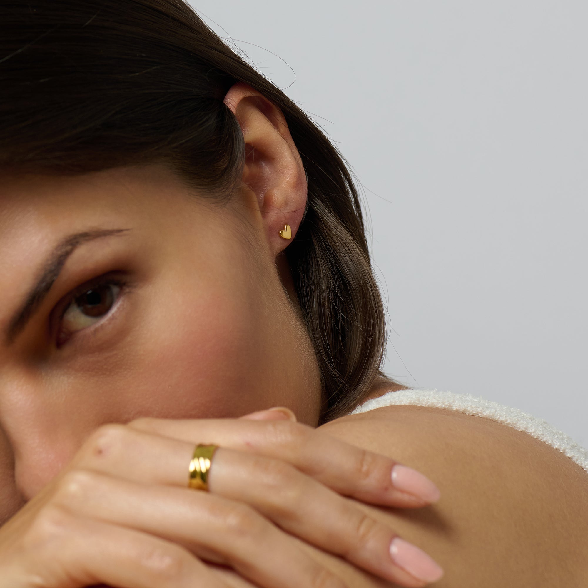 Dainty and radiant gold love heart stud earrings