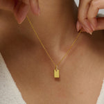 Gold initial tag pendant necklace with moissanites