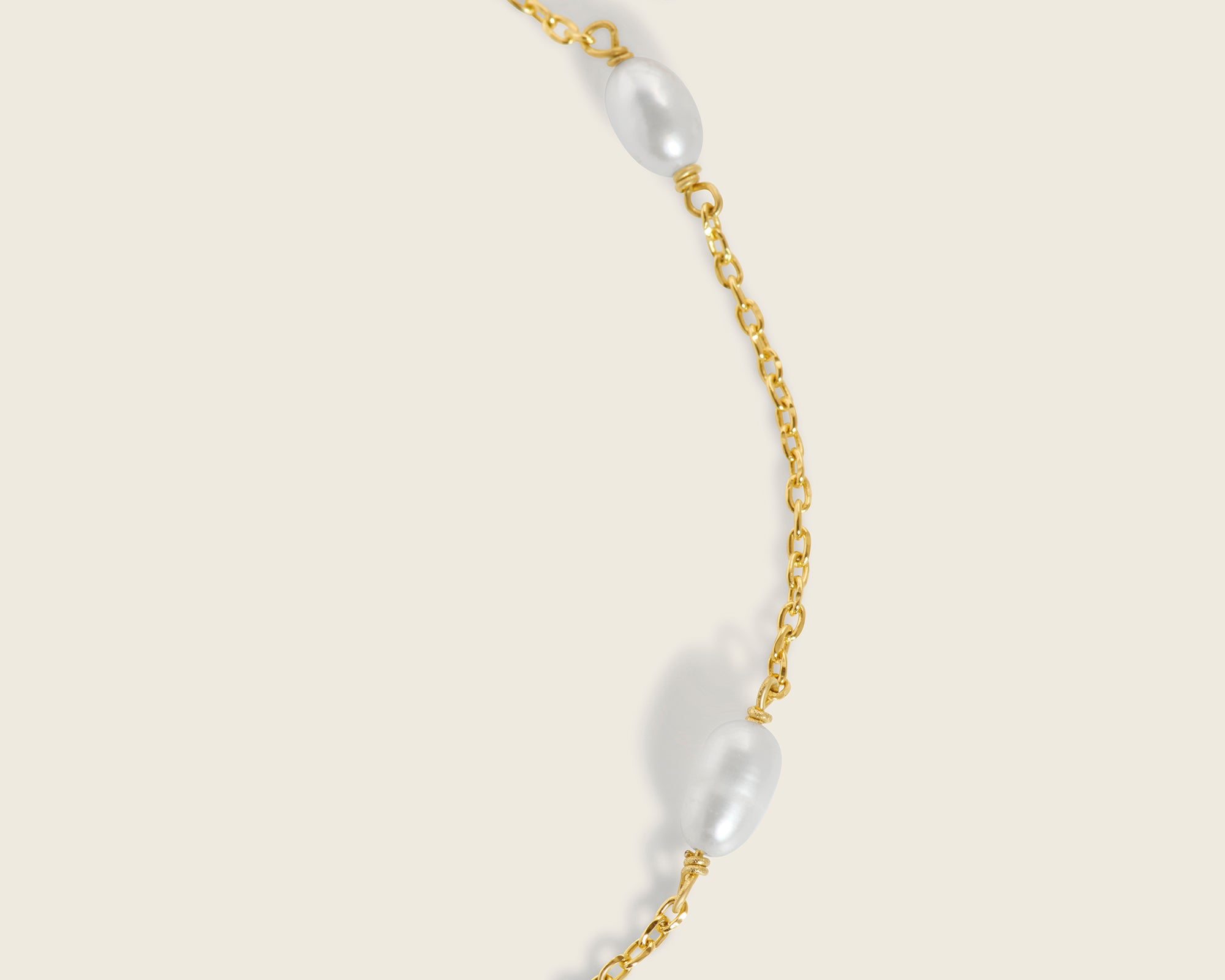 Radiant 18k gold paired with opulent freshwater pearls on an adjustable gold chain bracelet