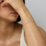 An 18k gold vermeil chain bracelet adorned with mini baroque freshwater pearls. Part of a matching set with gold pearl necklace.